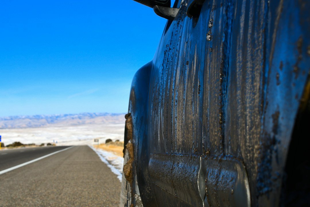 Vehicle covered in winter road salt and grime after a snowstorm