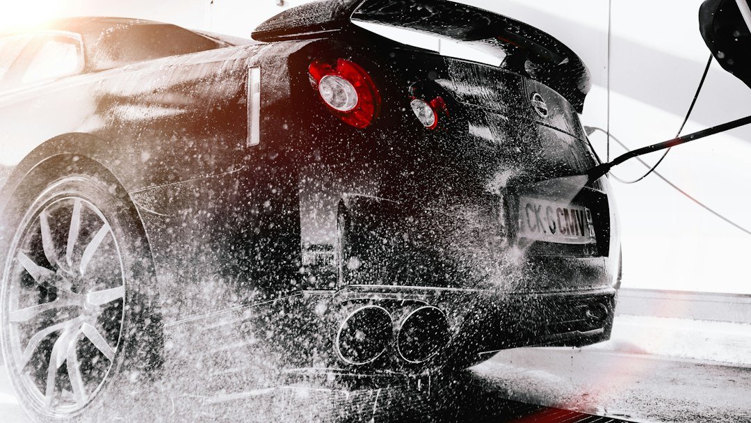 Car being washed with foam to remove winter road salt